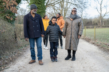 Three generation family walking together in rural area