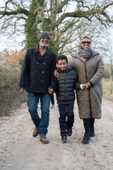 Boy with grandparents walking in rural setting