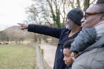 Boy with grandparents walking in rural setting