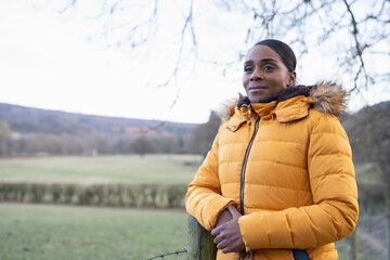 Portrait of woman wearing winter jacket in rural setting