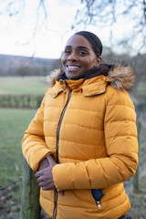 Portrait of woman wearing winter jacket in rural setting