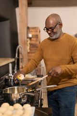 Senior man preparing food in kitchen