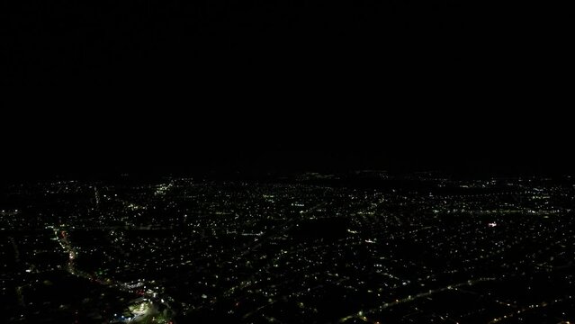 Aerial above the illuminated cityscape of Morelia at night in Michoacan, central Mexico