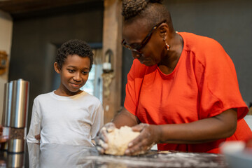 Senior woman with grandson preparing dough