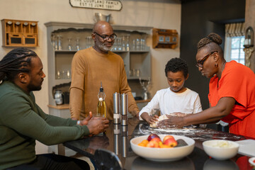 Family preparing together meal in kitchen