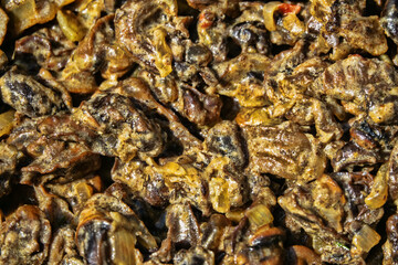 Hiker's food. Grape snails fried in a frying pan with vegetables