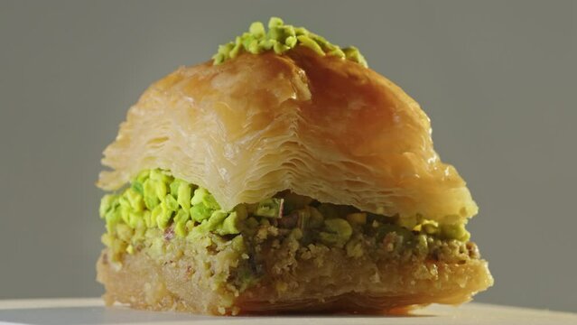 a slice of pistachio baklava turning