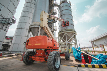 Male industry working at high in a boom liftinspection tank silo © chitsanupong