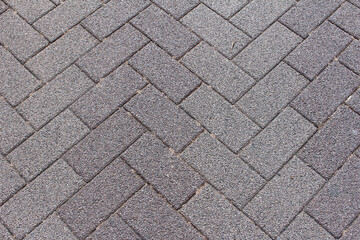 Texture of square cobblestone. Pattern of gray sidewalk tiles in the street. Gray square cobblestones close up.