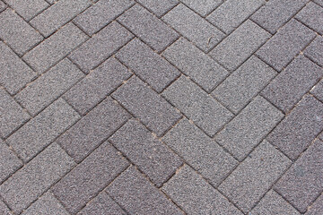 Texture of square cobblestone. Pattern of gray sidewalk tiles in the street. Gray square cobblestones close up.