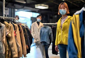 Fototapeta premium a volunteer goes through a lot of clothes. Used clothing donated. Second life for old things. Caring for the environment