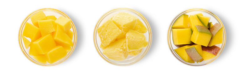 Slices of ripe mango with skin and frozen bites on white background.Top view.Macro.