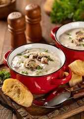 Bowls of creamy mushroom soup with sliced mushrooms and parsley