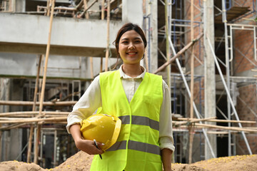 Portrait of a woman foreman working on a construction site with a reflective jacket and hard hat