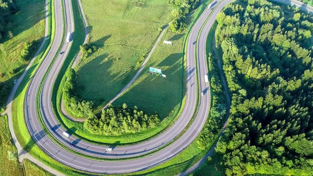 Poland. Winding switchback serpentine road from Krakow to Zakopane, called Zakopianka, near Rabka and Chabowka. Aerial 4K aerial video from above in sunrise light 