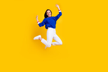 Fototapeta na wymiar Full body size photo of energetic funky woman in blue knitted pullover jumping careless at friday party isolated on yellow color background