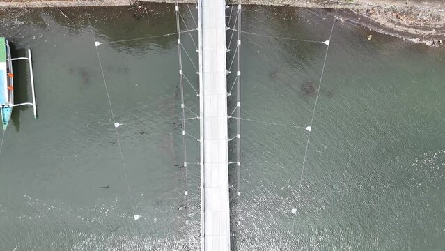 Suspension bridge for crossing

connecting Puyahan Village with Cemara Village. Lombok - NTB - Indonesia