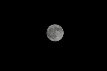Stunning full moon illuminated against a dark night sky