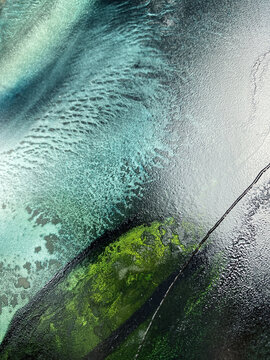 Abstract fluid art in green and turquoise tones. Hand-made with alcohol ink. Features organic flowing shapes. No real property or natural materials depicted.