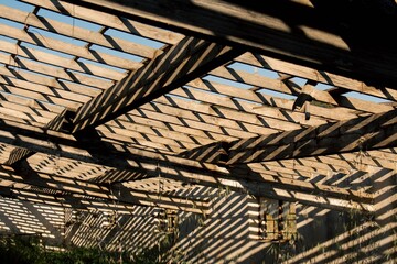 a roof made out of wooden beams attached to a building