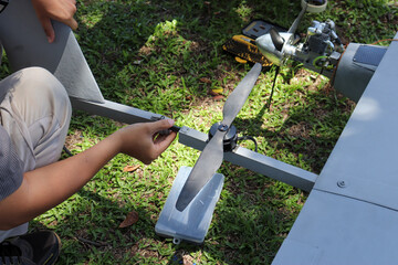 Engineer designing and assembling drones. Homemade aircraft made from resin and carbon fiber