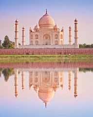 Taj Mahal famous marble mausoleum at sunset, on the south bank of the Yamuna river in the Indian...