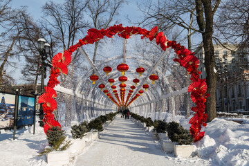 Chinese New Year in Moscow. Decorative tunnel with red decorative lanterns on Tverskoy Boulevard - 731828474