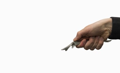 A hand holding a bottle opener on a white background