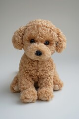 A small puppy, curly, plush, brown, a soft toy for children.  