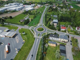 View of a quaint, small town situated in a rural landscape with a roundabout