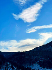 Fototapeta premium Blue sky with clouds and mountains