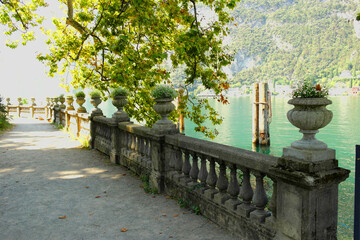 View of Lake Garda with beautiful flowers and tourists. August 15, 2023 Riva del Garda, Italy.​