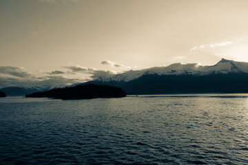Early morning sun rising behind mountains aloing inside passage