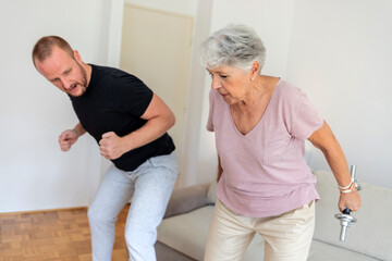 Obraz premium Elderly woman, dumbbells and rehabilitation therapist for exercise in a nursing home. Happy senior patient with physiotherapist man or nurse for healing, health and physiotherapy for muscle and body.