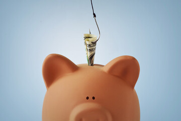 Piggy bank with money and fishing hook - Concept of phishing and stealing money - 731848027