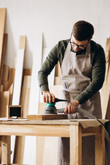 Carpenter working with wood and saw in the manufacturing industry