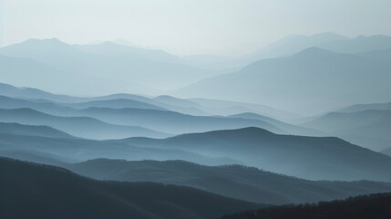 In the distance the mountains are ly visible through the mist giving a sense of depth and vastness to the landscape. - obrazy, fototapety, plakaty