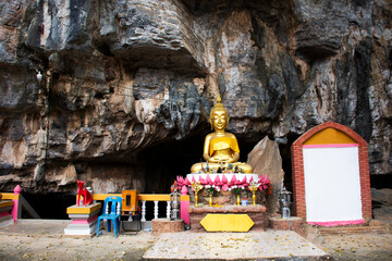 Ancient holy buddha statue in antique mystery cave for thai people traveler travel visit respect...