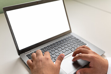 Hands typing on a laptop