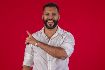 Man, with a beard, in a white shirt, with various facial expressions, on a red studio background