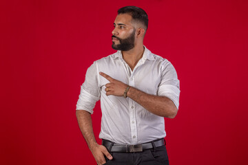 Man, with a beard, in a white shirt, with various facial expressions, on a red studio background