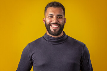 Man with beard wearing black shirt, with various facial expressions
