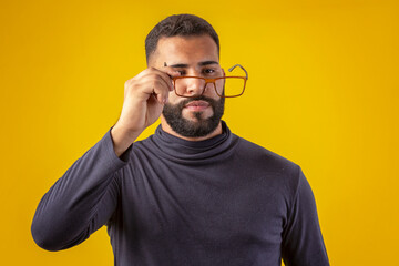 Man with beard wearing glasses, black shirt, with various facial expressions