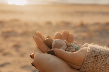 hand holding a bunch of stones