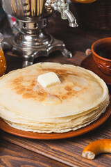 Tea party with pancakes, samovar tea and pickles