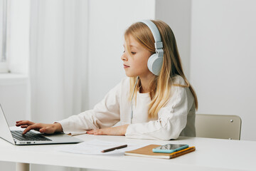 Happy Teenage Girl Learning Online Using Laptop for eLearning at Home Description A cute, smiling...