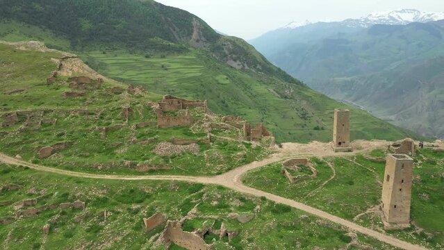 Famous ruined towers of old Goor village in Dagestan. Scenery rocky mountains. Aerial footage.