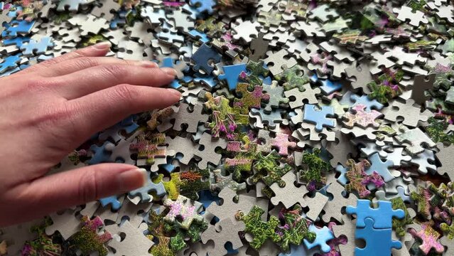 Play the puzzle game, select the right piece, woman hand, hobby, spending good time, close up, 4k
