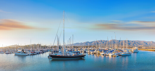 Sunset over Marina with docked boats with Santa Barbara Mountains on the background