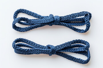 Two new shoelaces on white, dark-blue laces, top view. - obrazy, fototapety, plakaty
